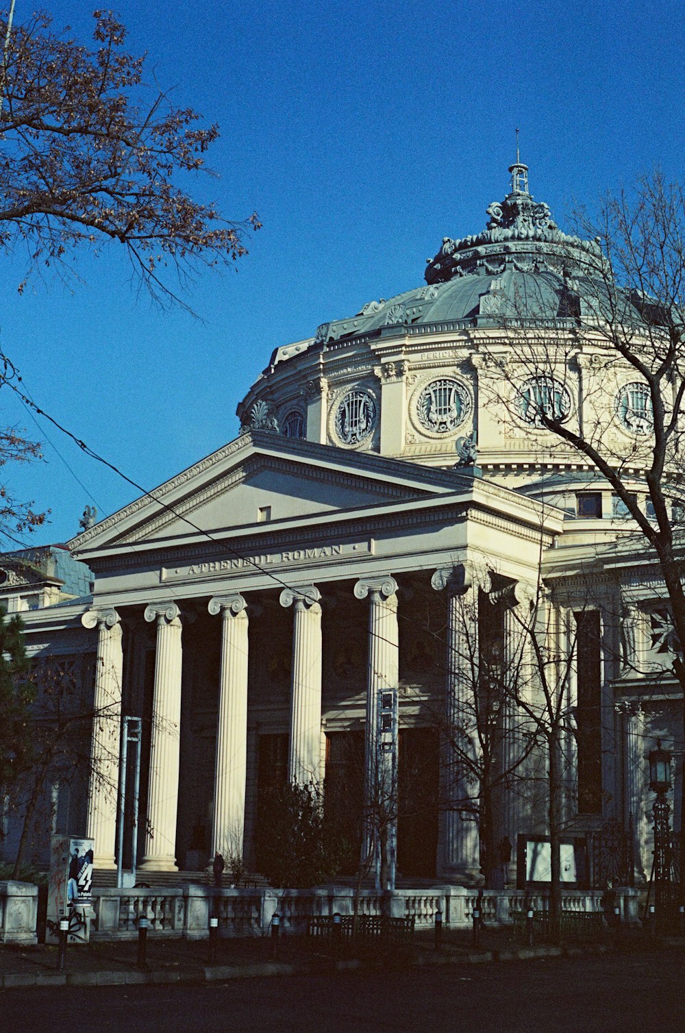 a large building with columns and a clock tower