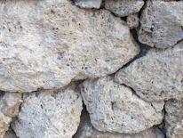 Close-up of raw limestone rocks freshly extracted from the mine.