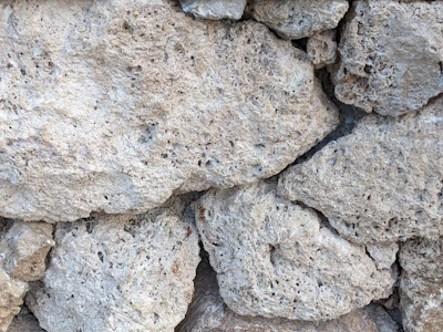 Close-up of raw limestone rocks freshly extracted from the mine.