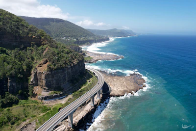 an aerial view of a highway next to the ocean