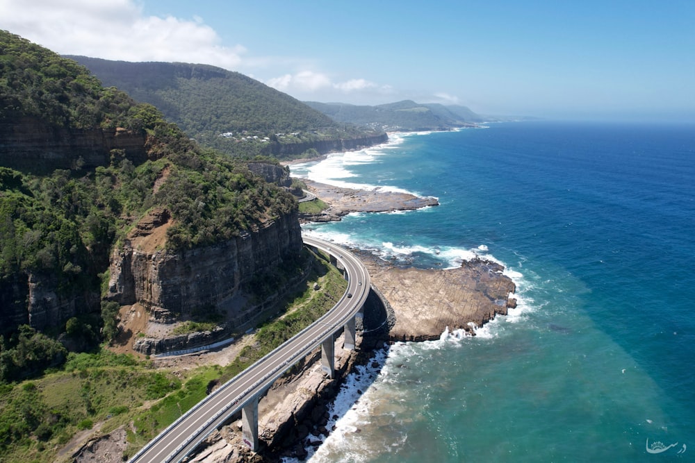 an aerial view of a highway next to the ocean