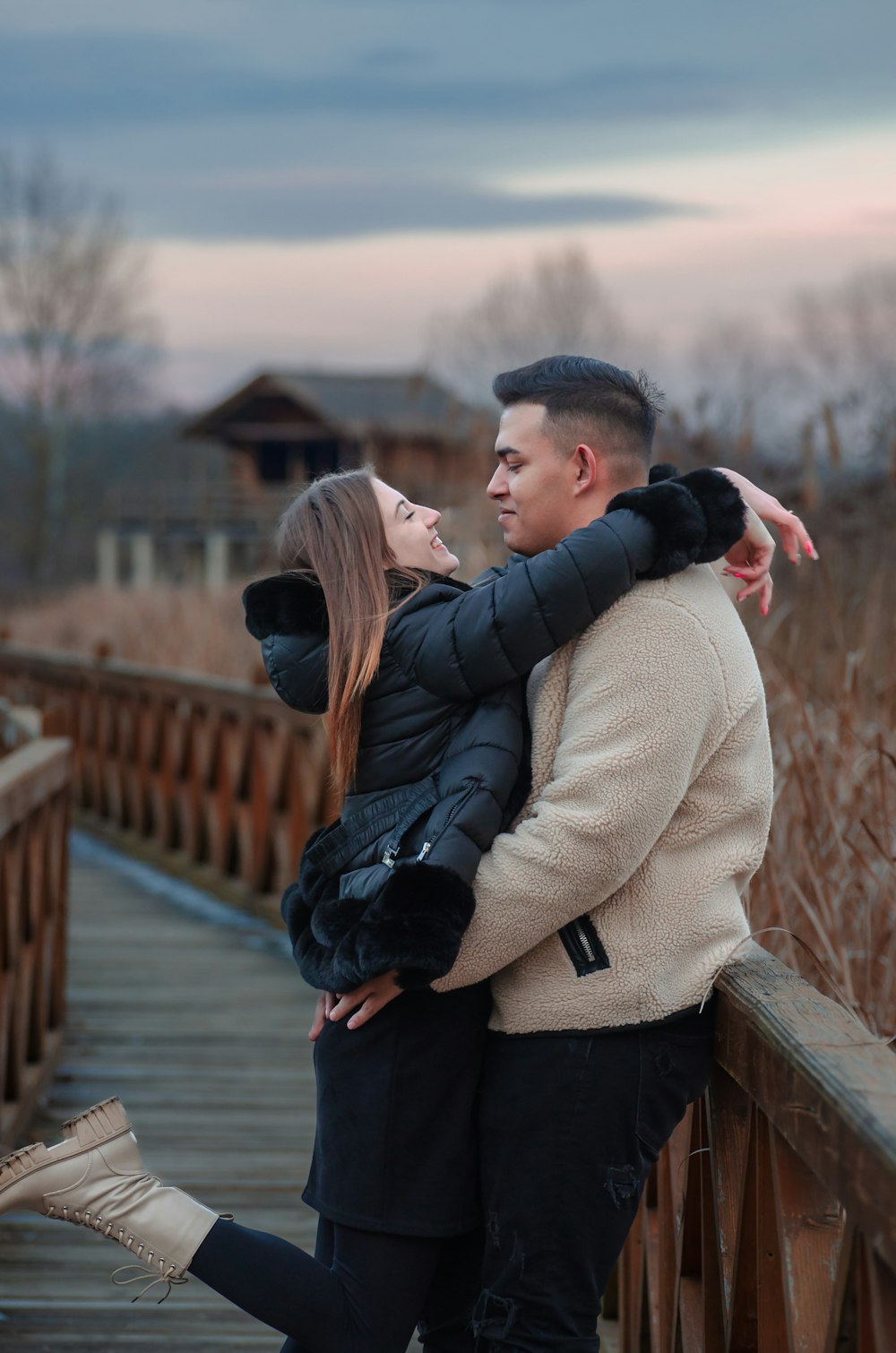 a man and a woman standing on a bridge