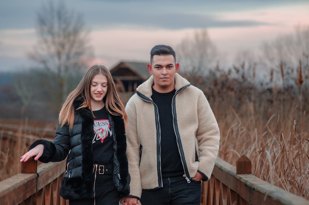 a man and a woman standing on a bridge