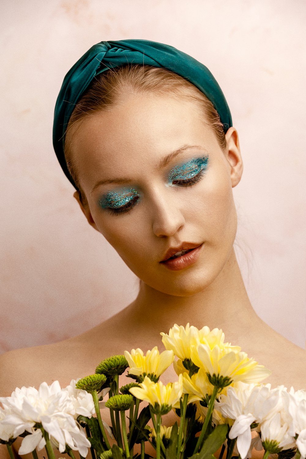 a woman with blue eyes and a green headband