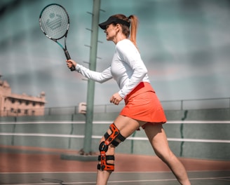 a woman with a tennis racket on a tennis court