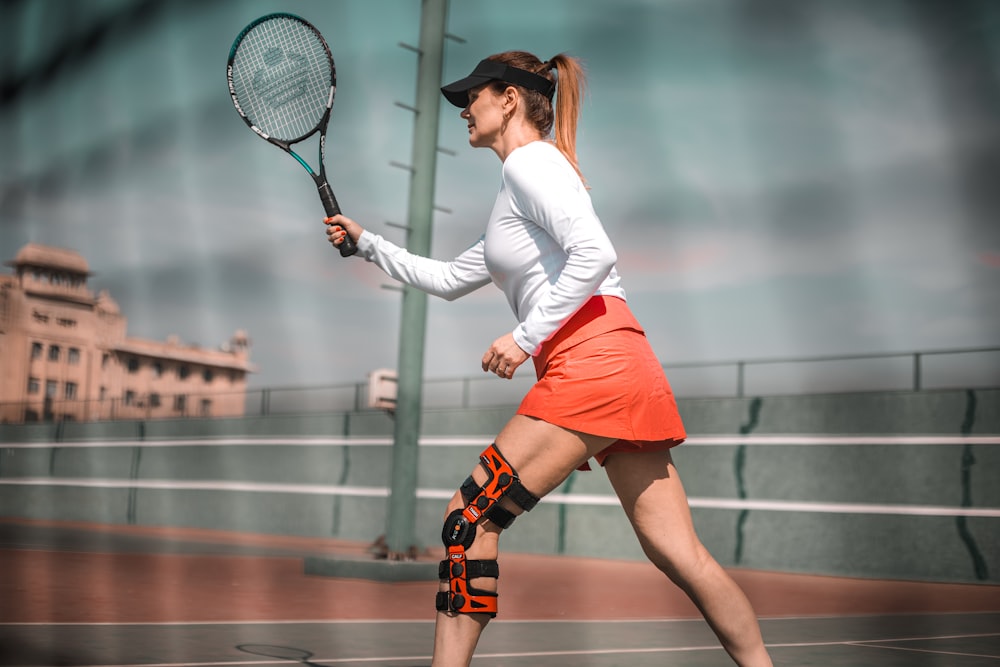 a woman with a tennis racket on a tennis court