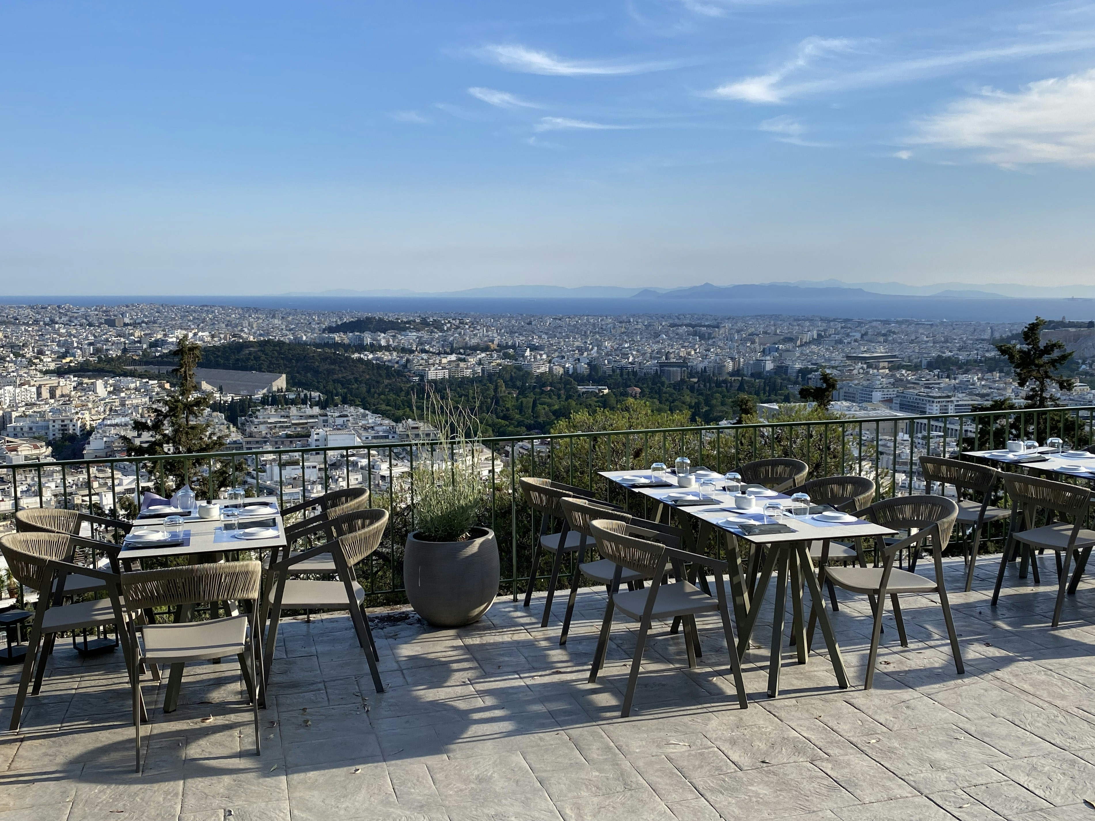 upscale rooftop dining setup with scenic skyline view