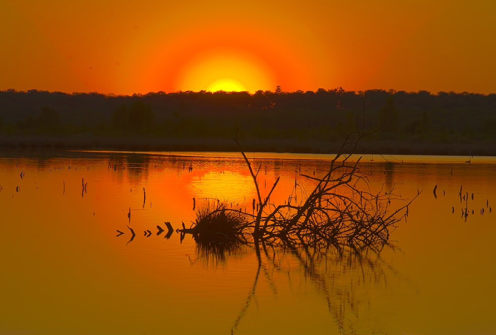 the sun is setting over a body of water