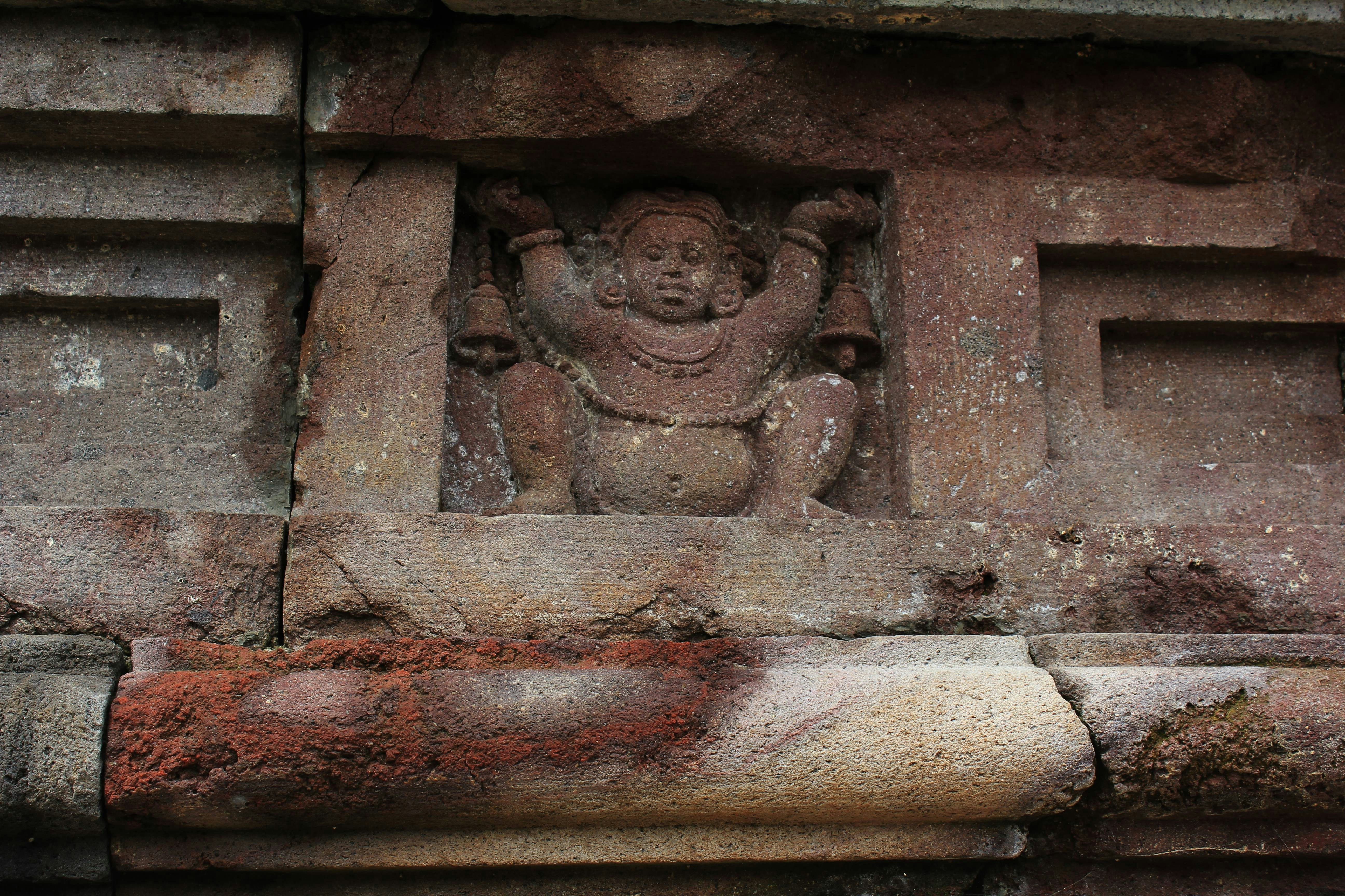 a stone carving of a buddha on a wall