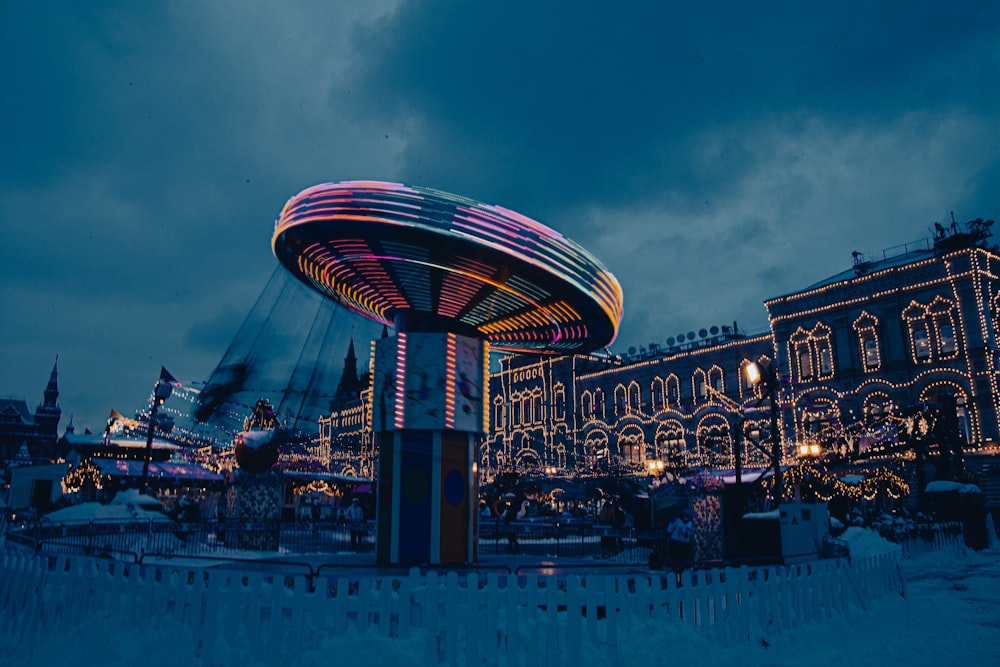 a carousel in the middle of a city at night