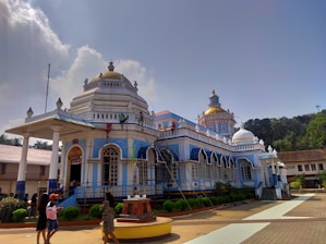 a blue and white building with two people standing in front of it