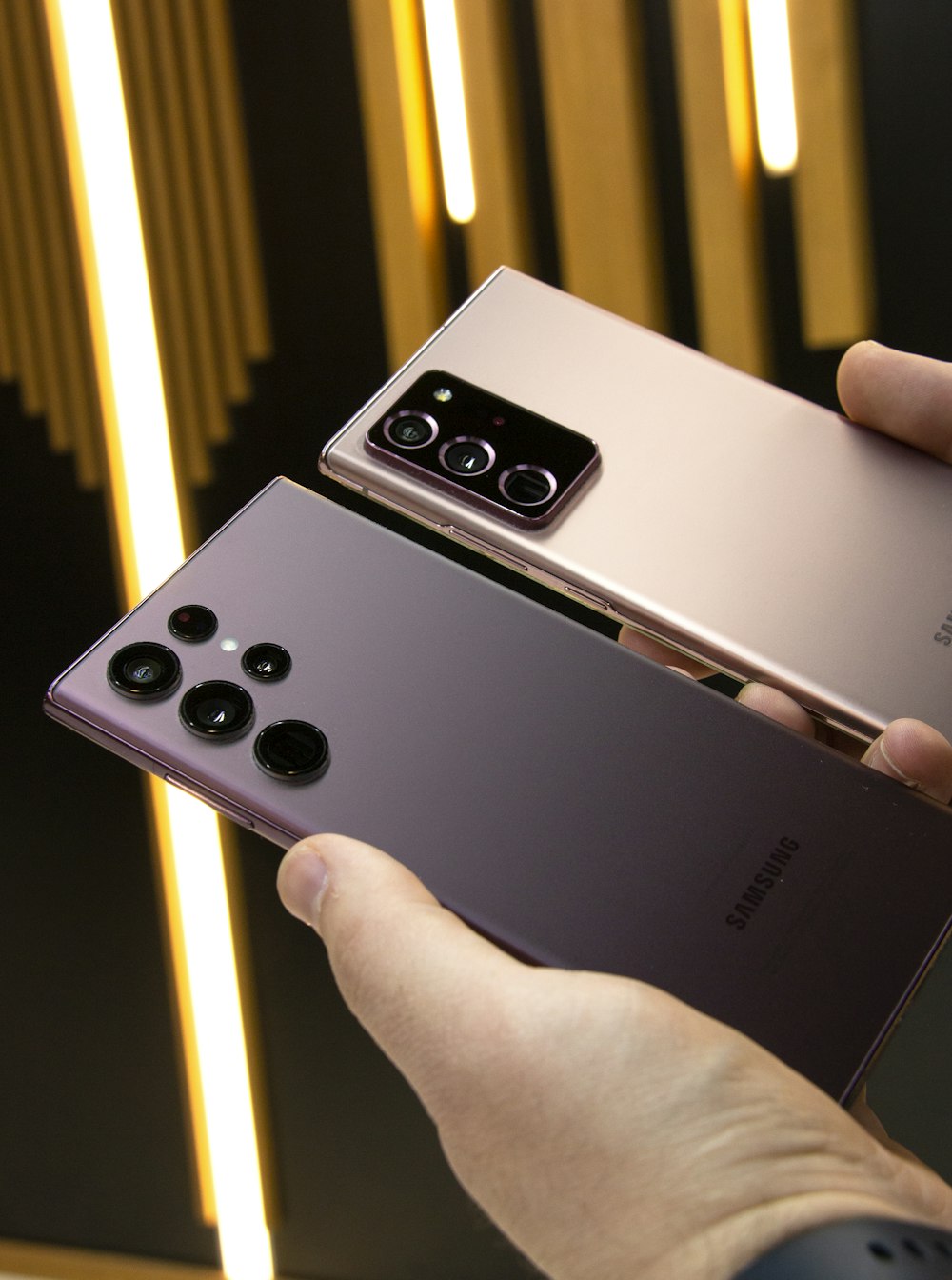 a person holding a samsung note 9 in their hand