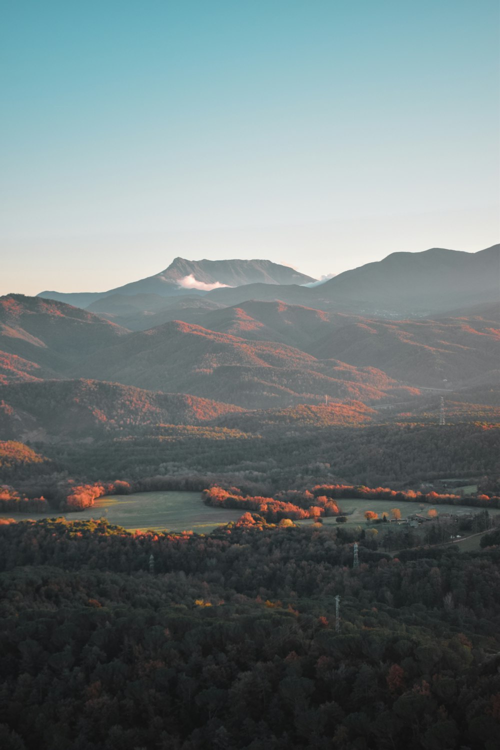 a scenic view of a mountain range with a lake in the foreground