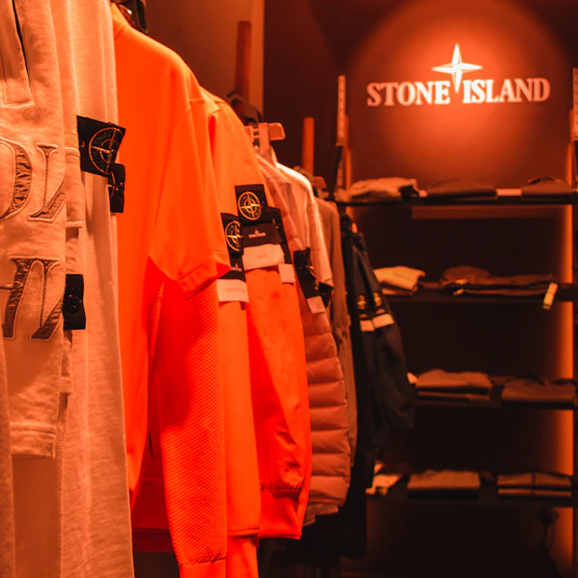 A store rail filled with lots of orange shirts