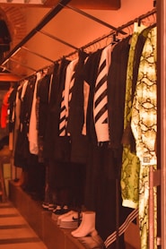 a row of shirts and ties hanging on a rack