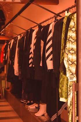 a row of shirts and ties hanging on a rack