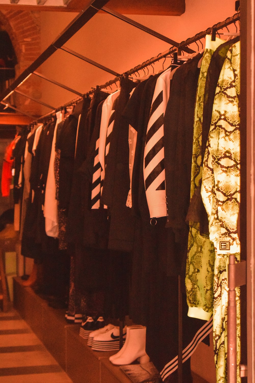 a row of shirts and ties hanging on a rack