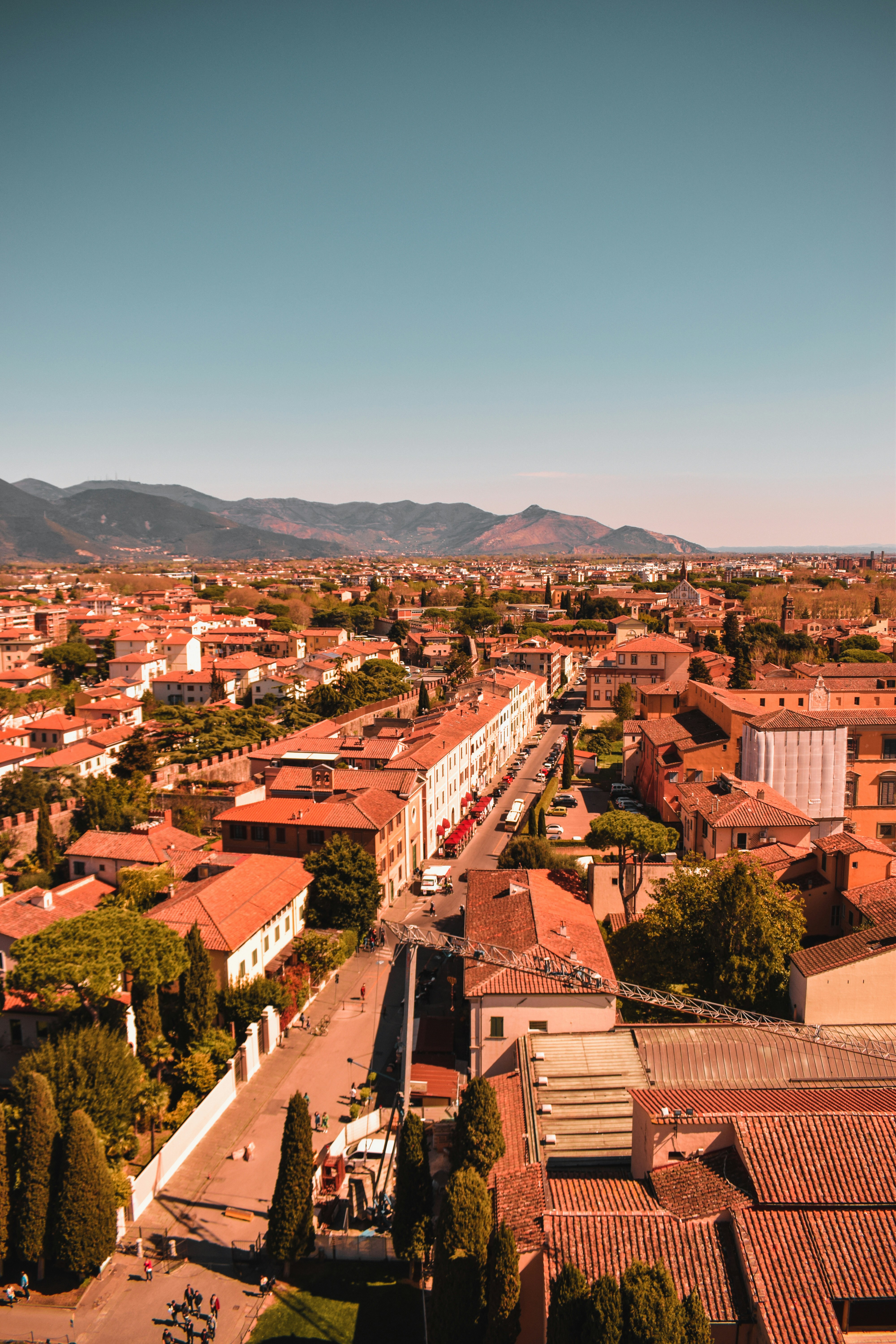 an aerial view of a city with mountains in the background