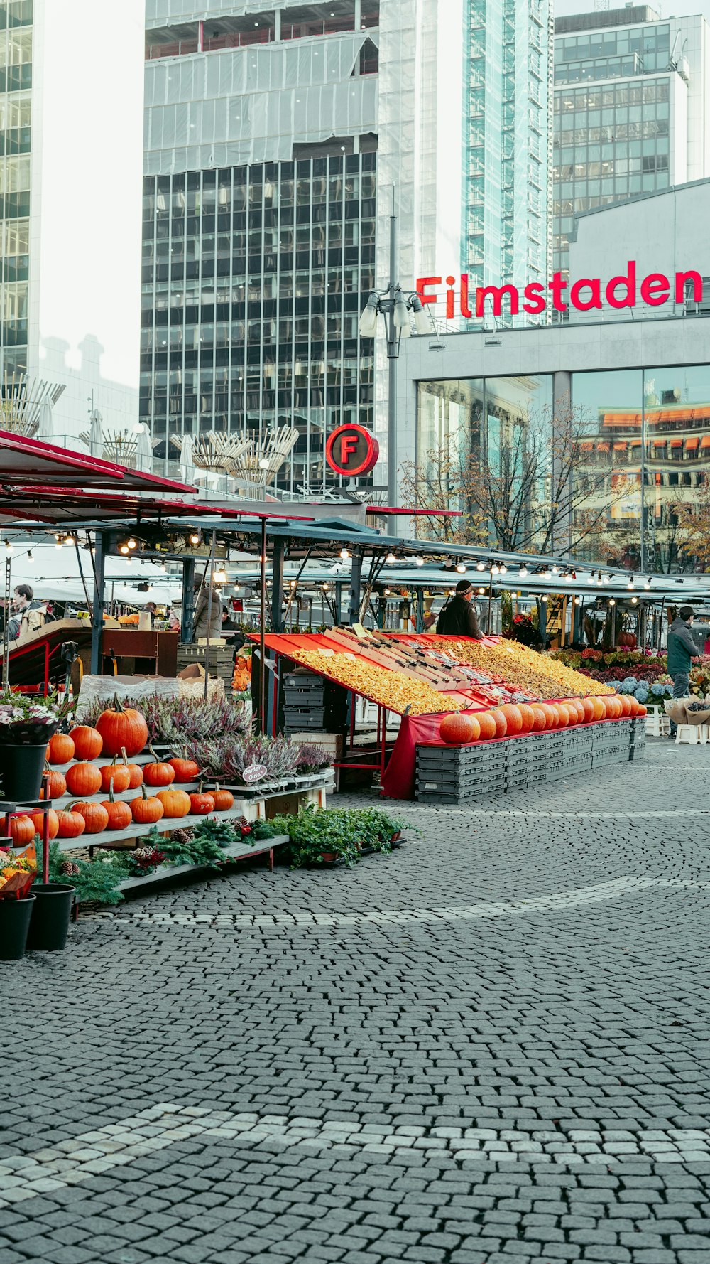 an outdoor market with lots of fruits and vegetables