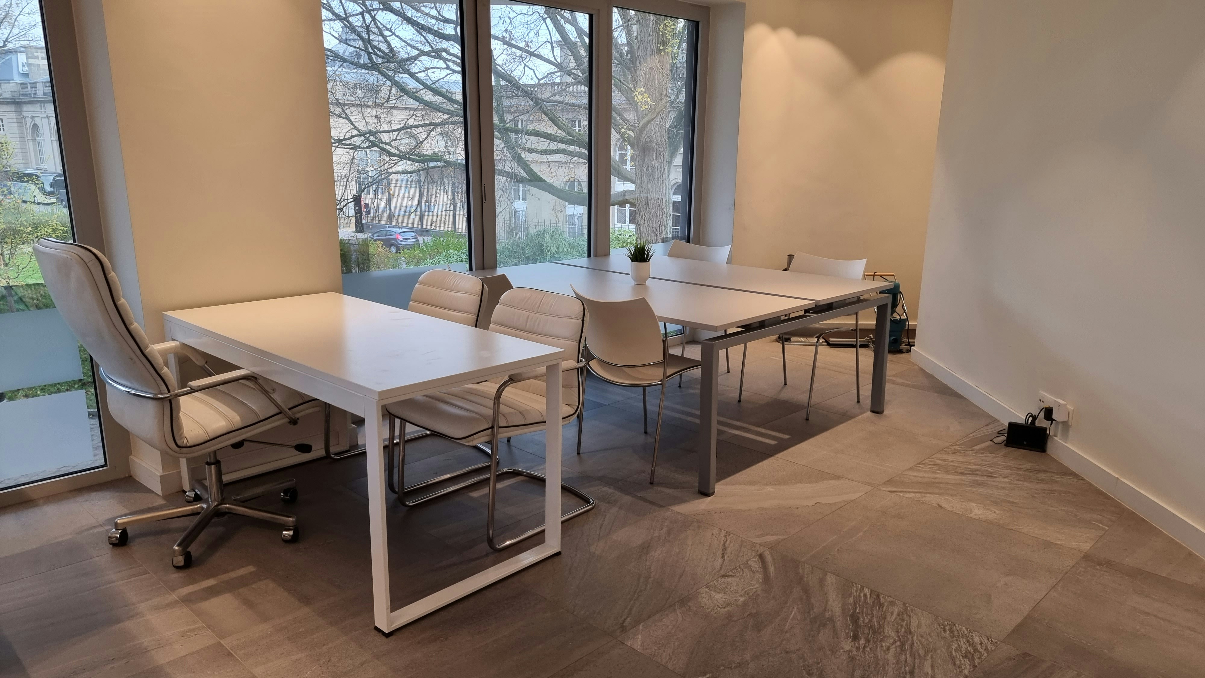 Bright contemporary boardroom with large windows and natural light, clean professional meeting space