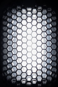 Close-up of a glowing graphene lattice structure with orange highlights on a black background.