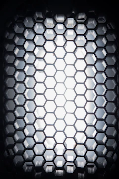 Close-up of a hexagonal pattern glowing softly in metallic silver and ocean blue.