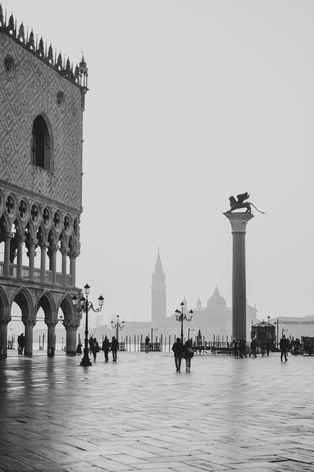 a black and white photo of a city square