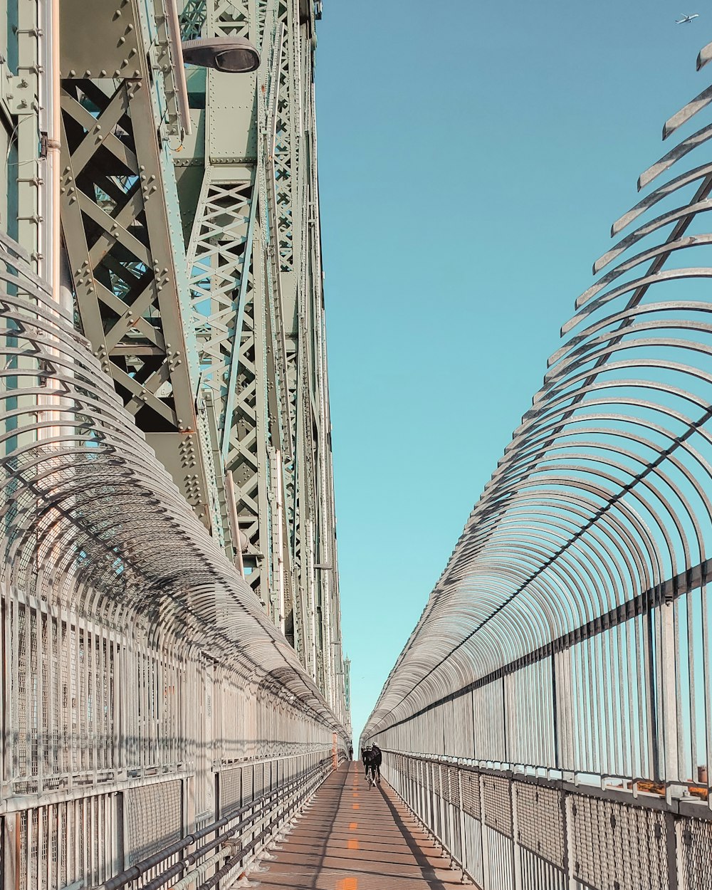 a long bridge with a person walking across it