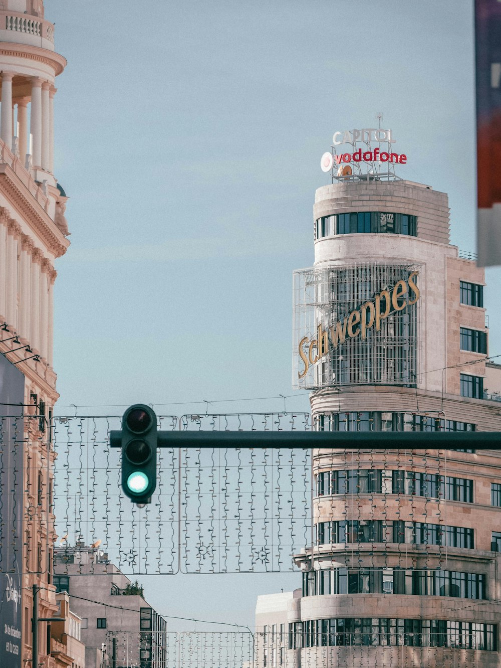 a traffic light in front of a tall building