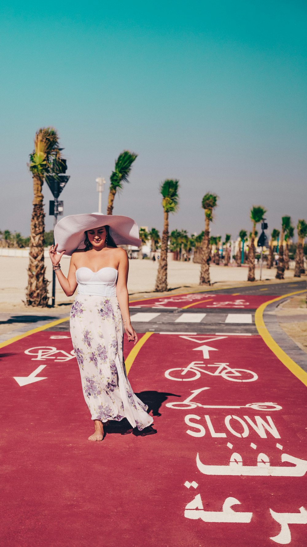 a woman in a white dress and a pink hat