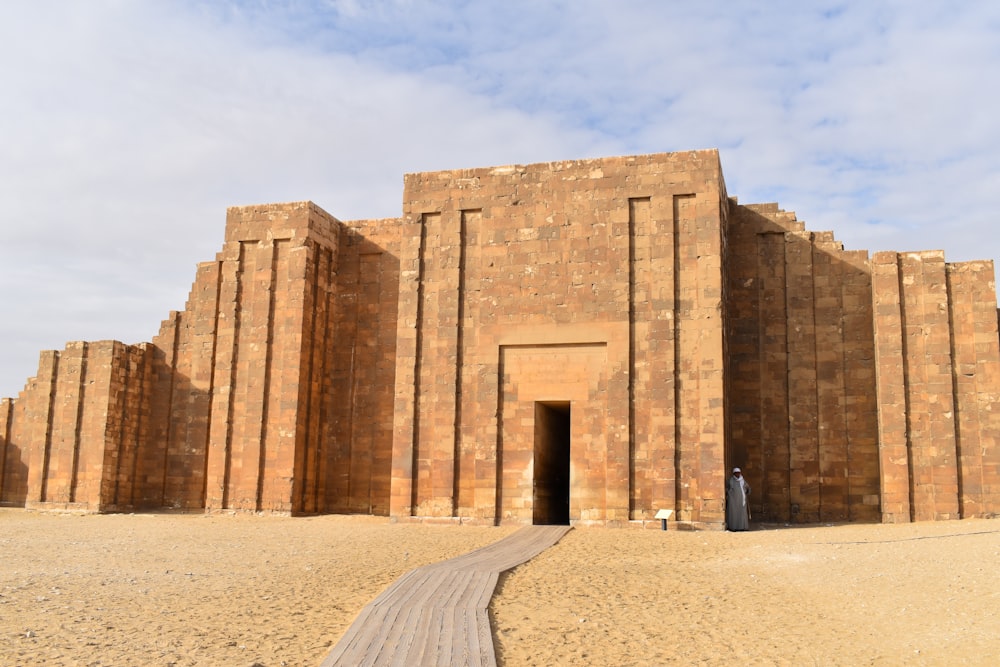 a large brick building with a walkway leading to it