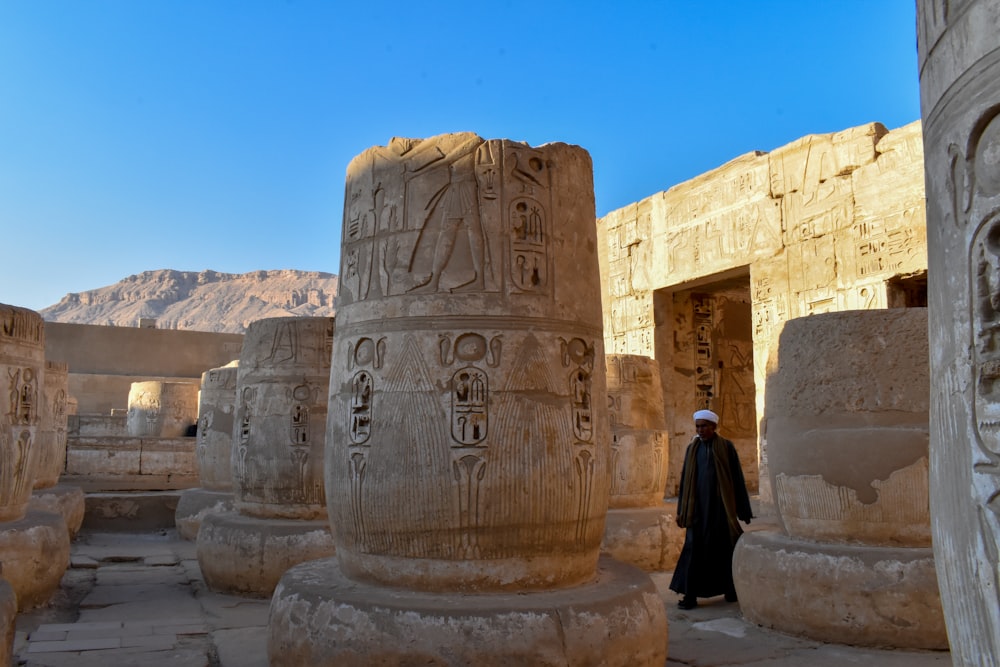 a man standing in front of some very large columns