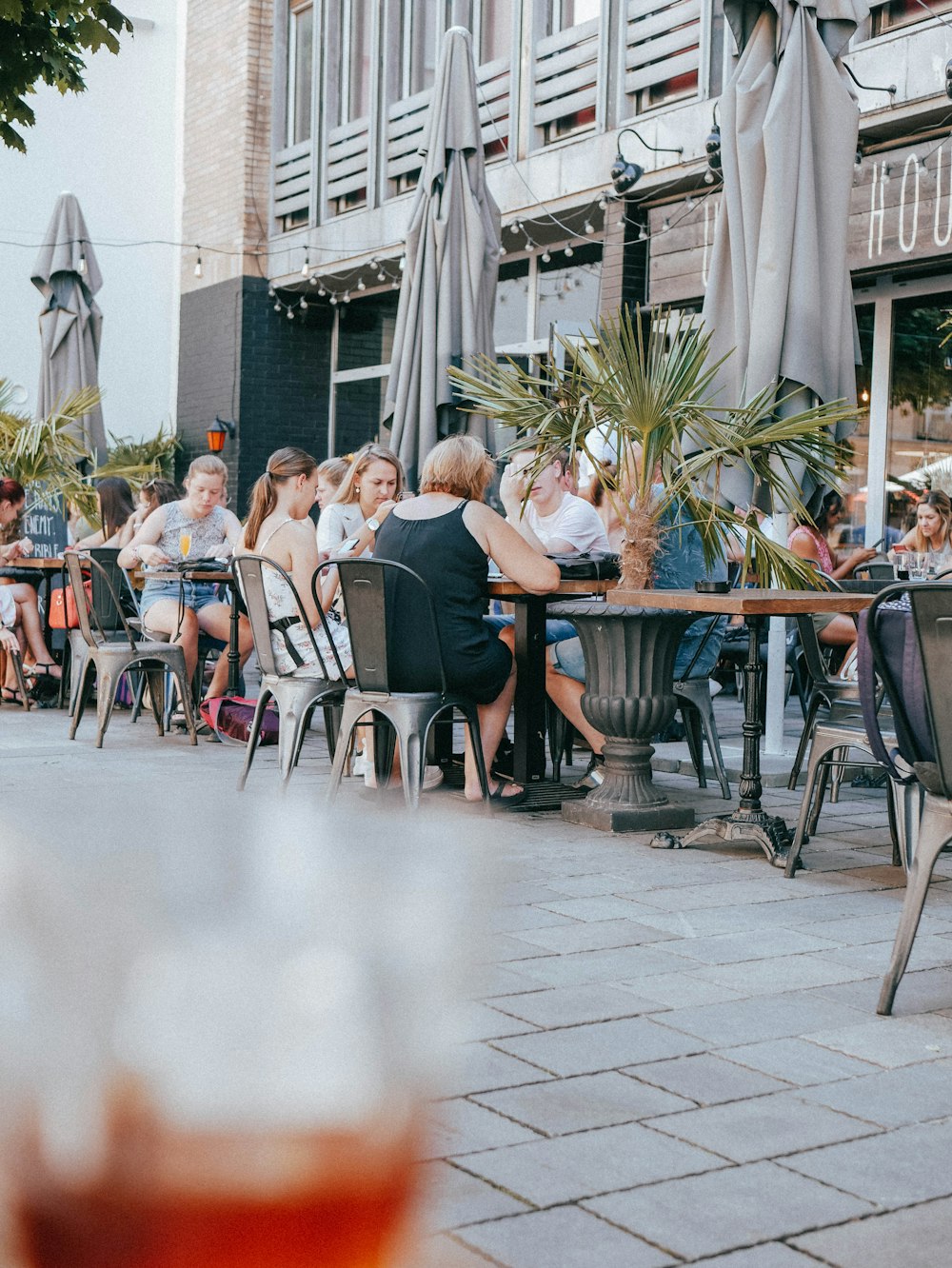 a group of people sitting at a table outside