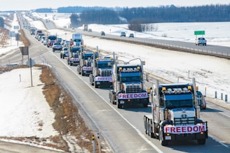 a long line of trucks driving down a highway