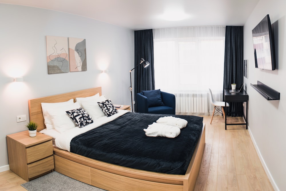 a bedroom with a large bed and a blue chair