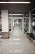 a long hallway with a bench in the middle of it