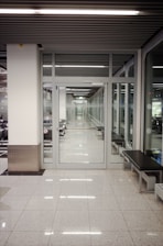 a long hallway with a bench in the middle of it