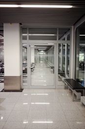 a long hallway with a bench in the middle of it