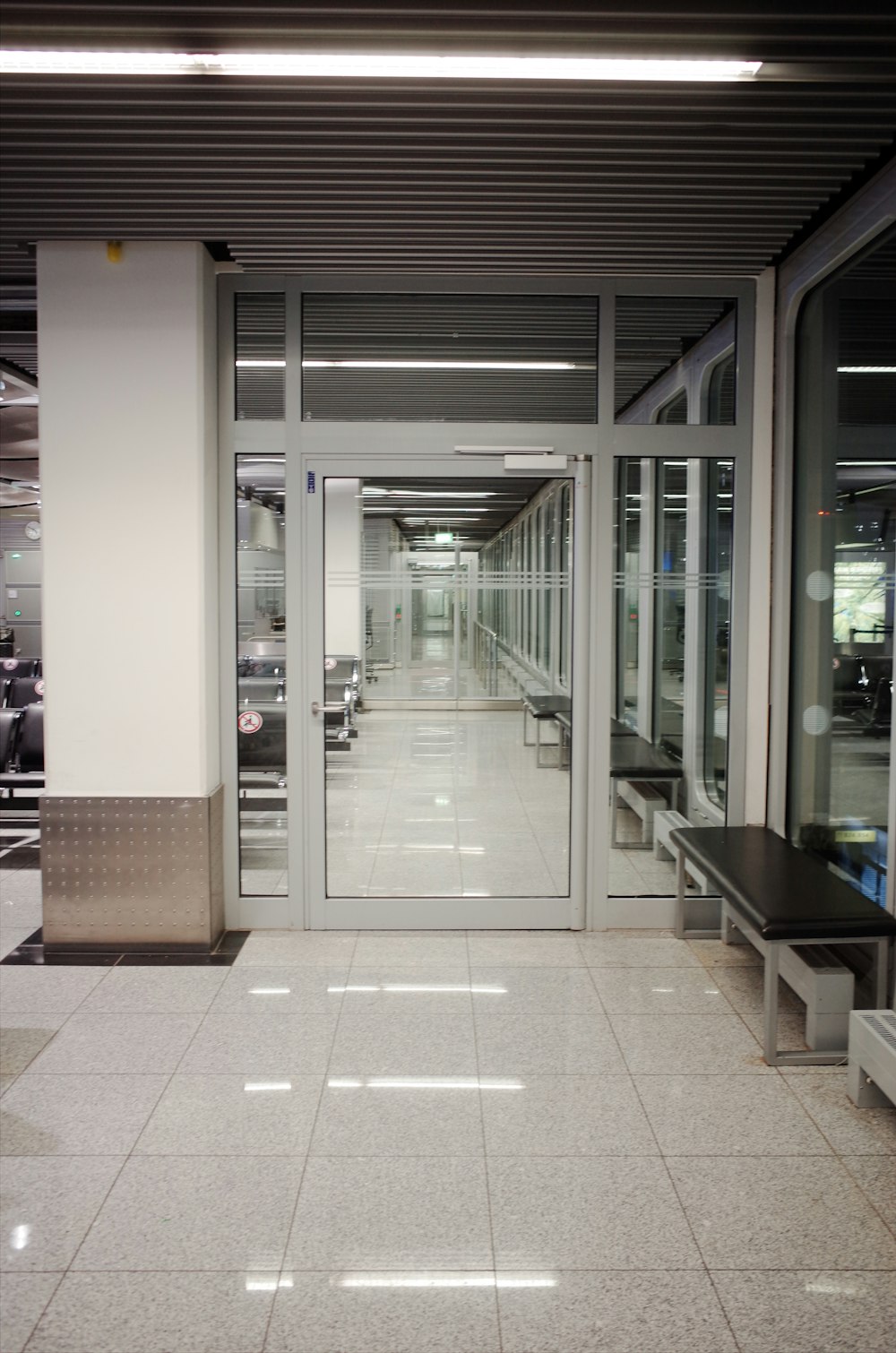 a long hallway with a bench in the middle of it