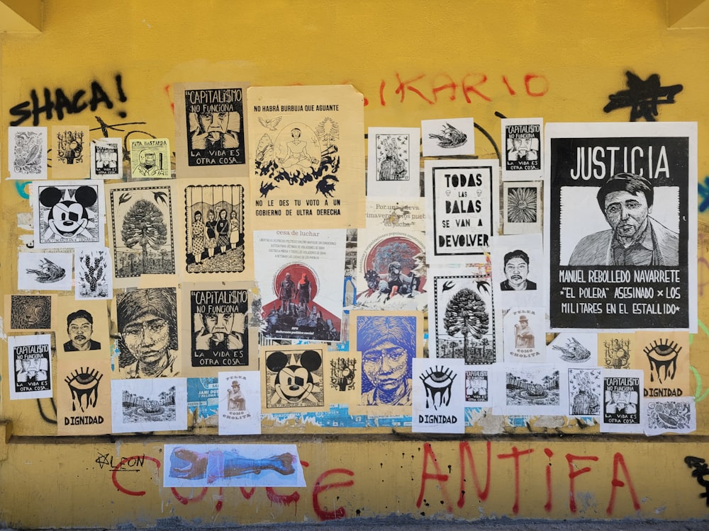 a wall covered in posters and stickers