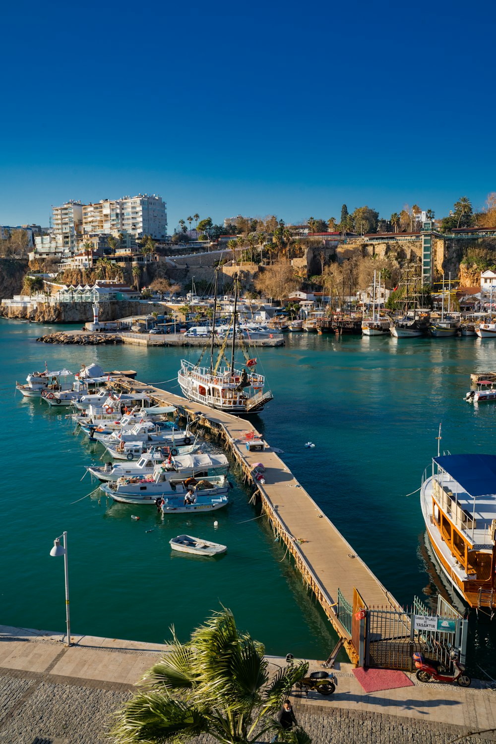 a harbor filled with lots of boats next to a city