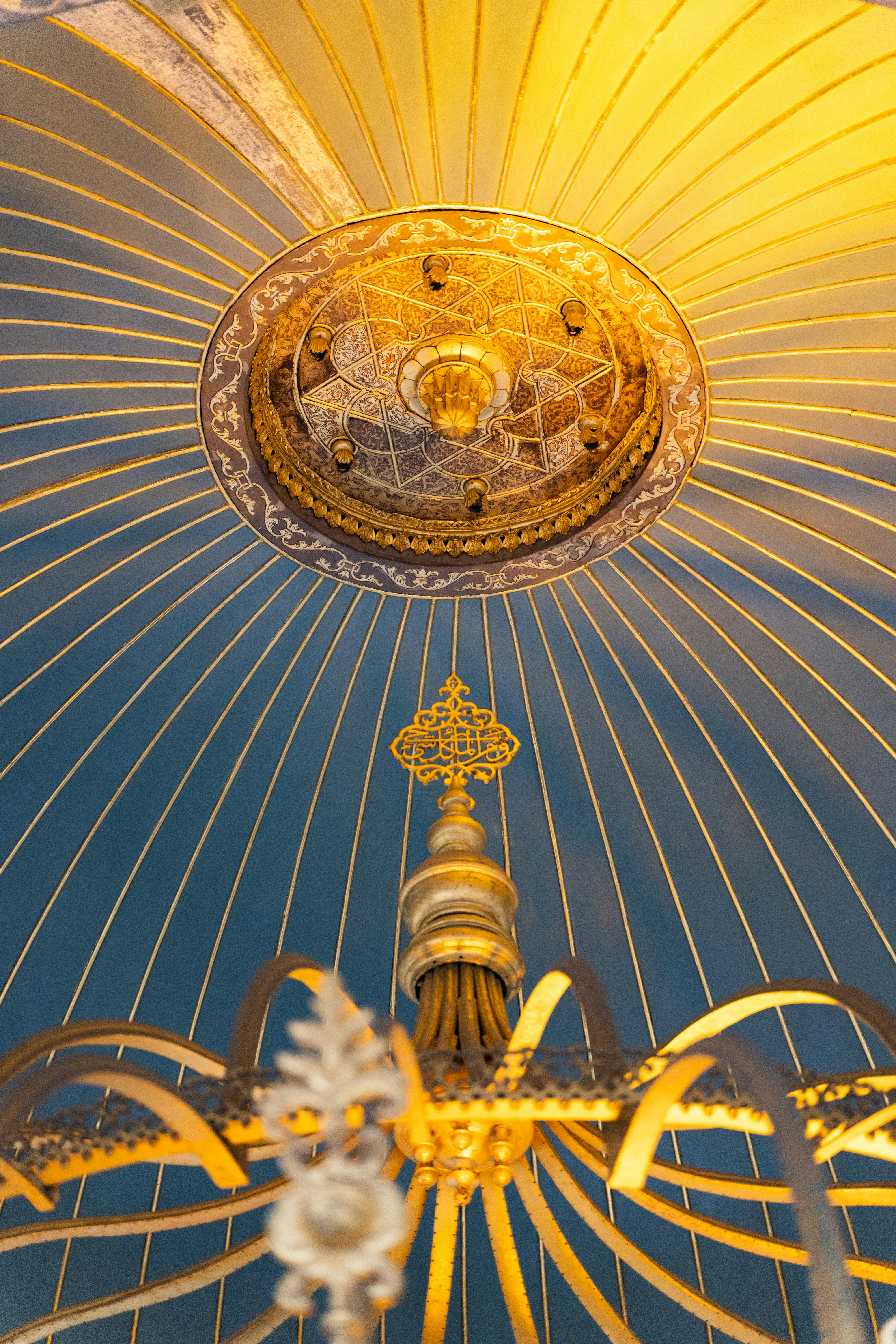 a close up of a yellow umbrella with a blue sky in the background