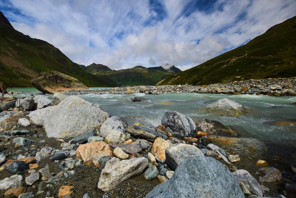 a mountain river with rocks and boulders in the foreground