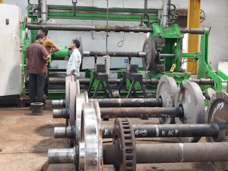 a couple of men standing next to a machine