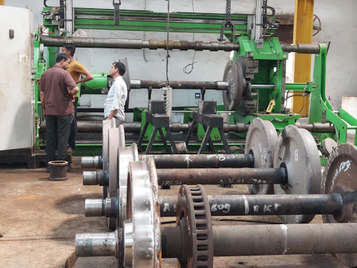 a couple of men standing next to a machine