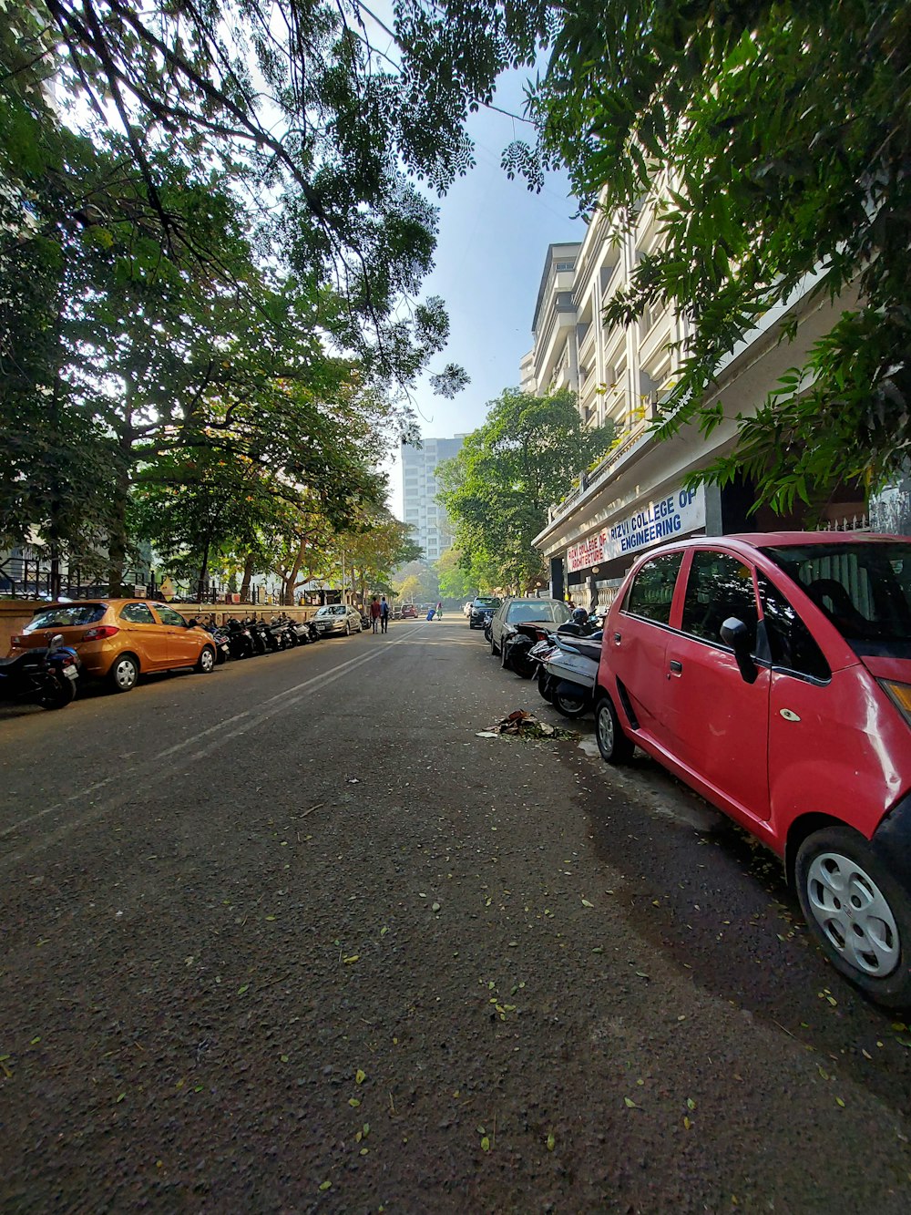 a small red car parked on the side of a road