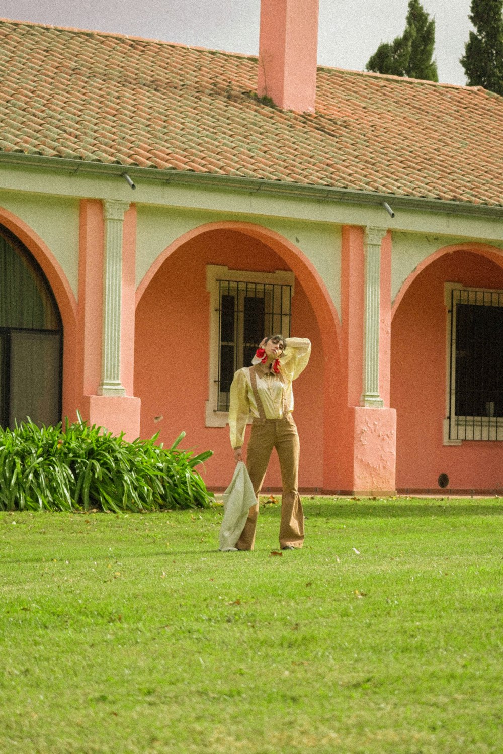 a man walking across a lush green field