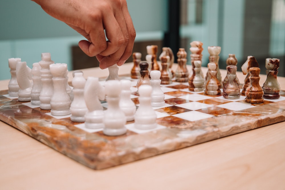 a person playing a game of chess on a table