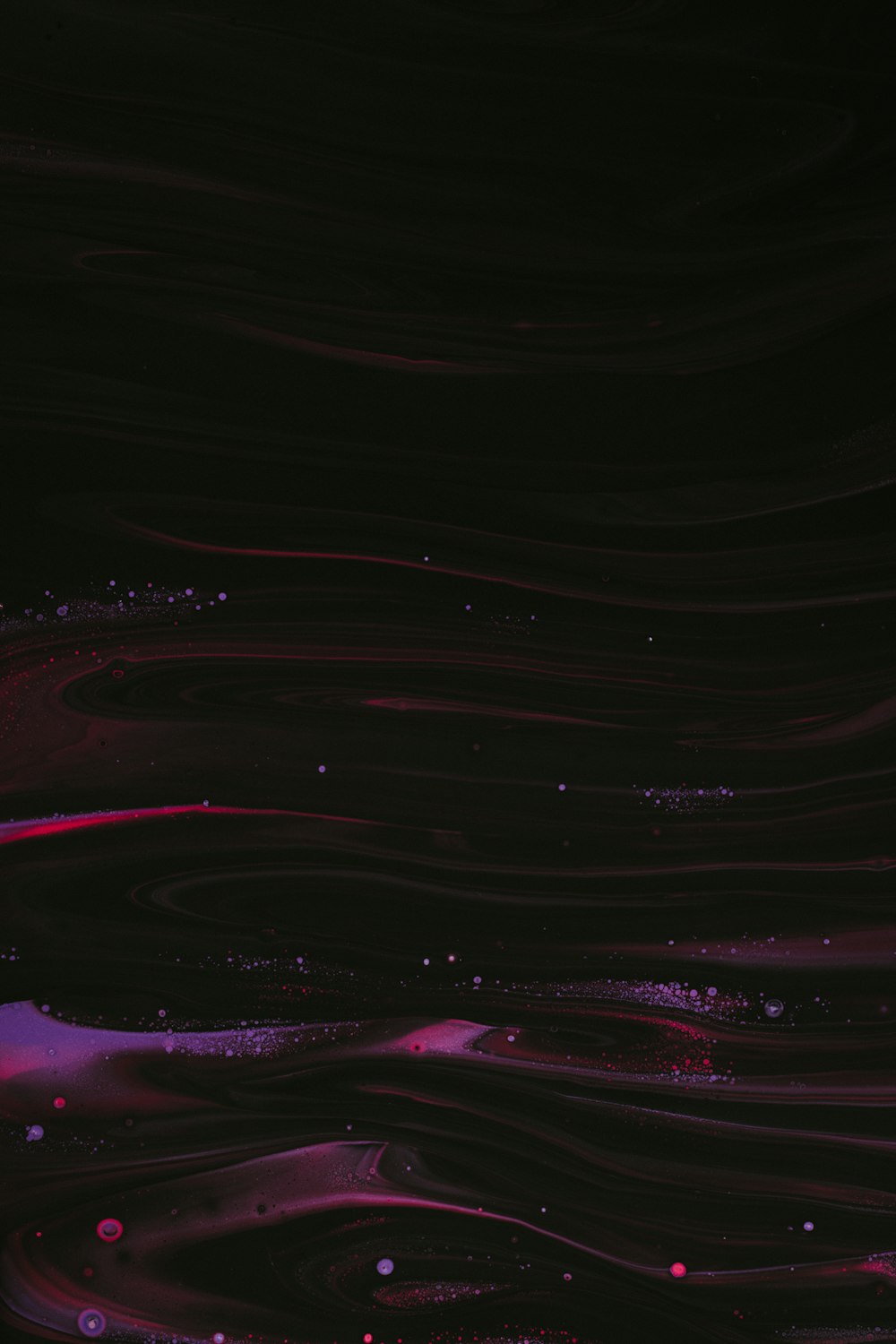 a black background with pink and purple swirls