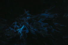 a black background with blue swirls in the middle